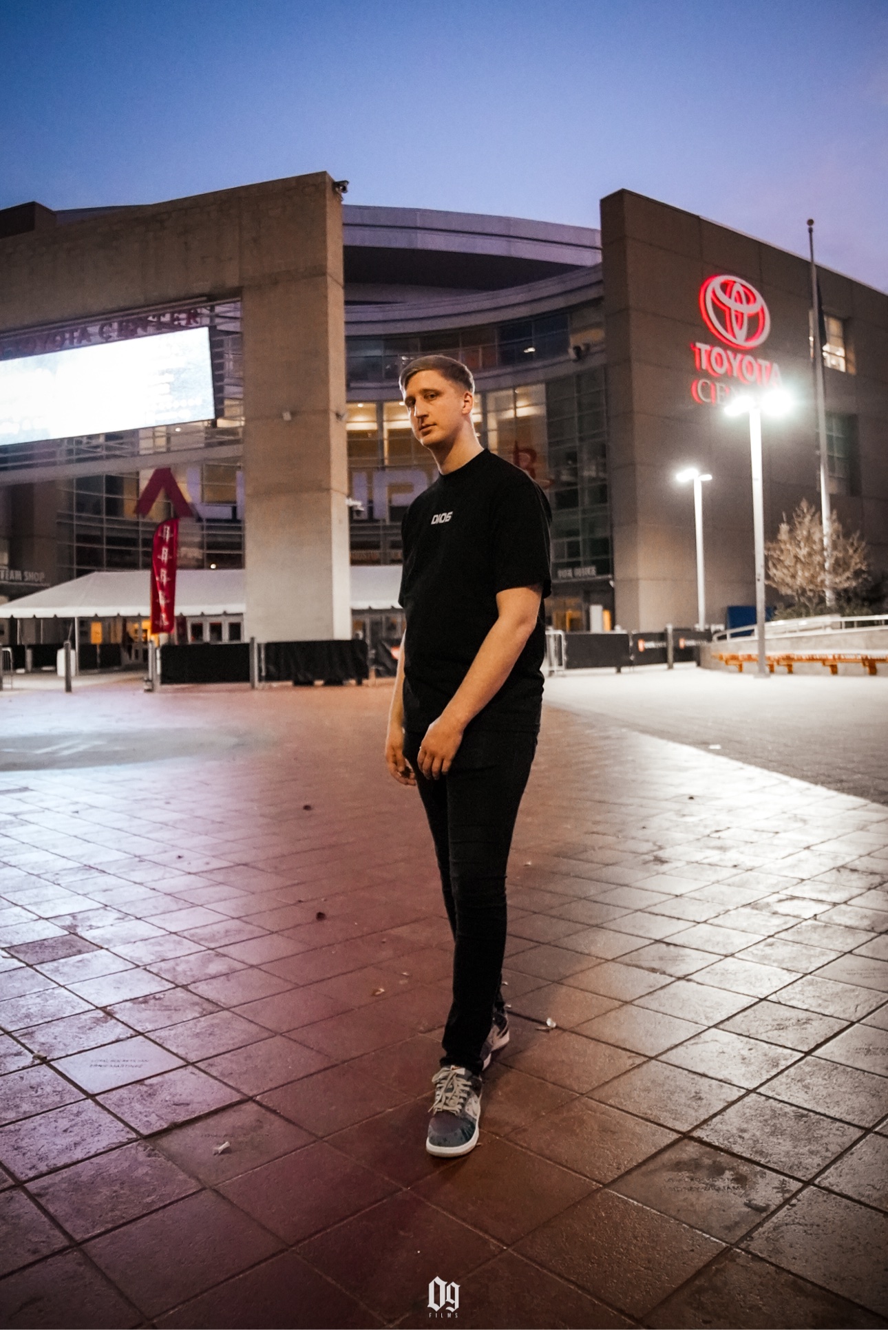 C-Hold standing outside Toyota Center at night in Houston